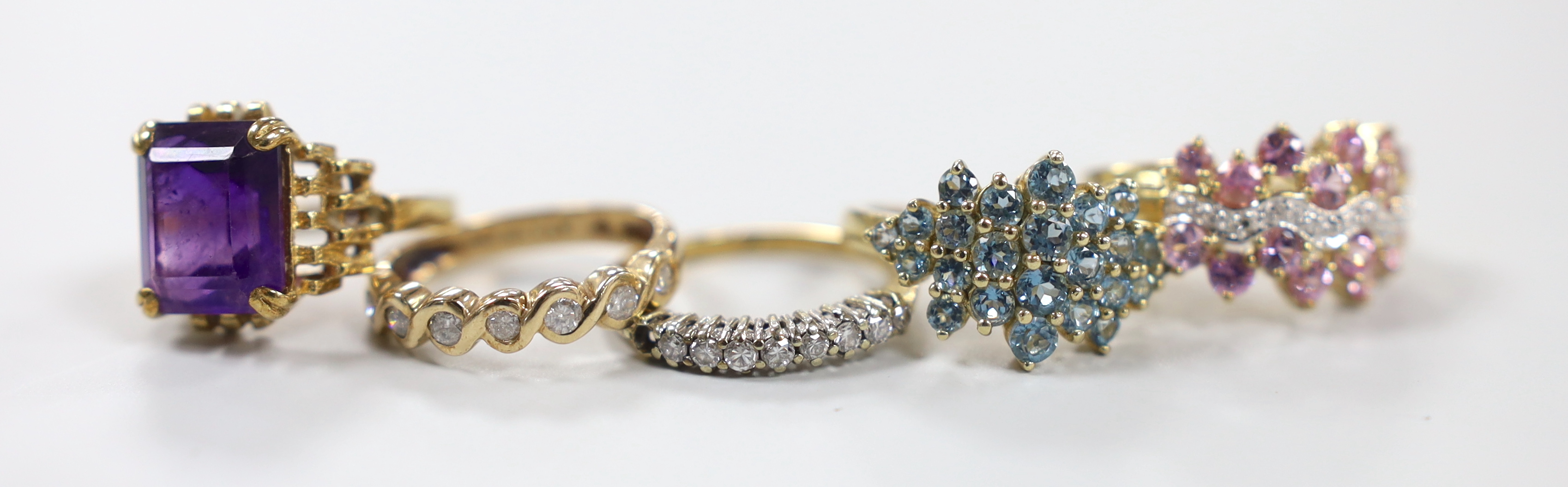 Five assorted modern 9ct gold and gem set rings, including two diamond set half hoop, gross weight 15.8 grams.